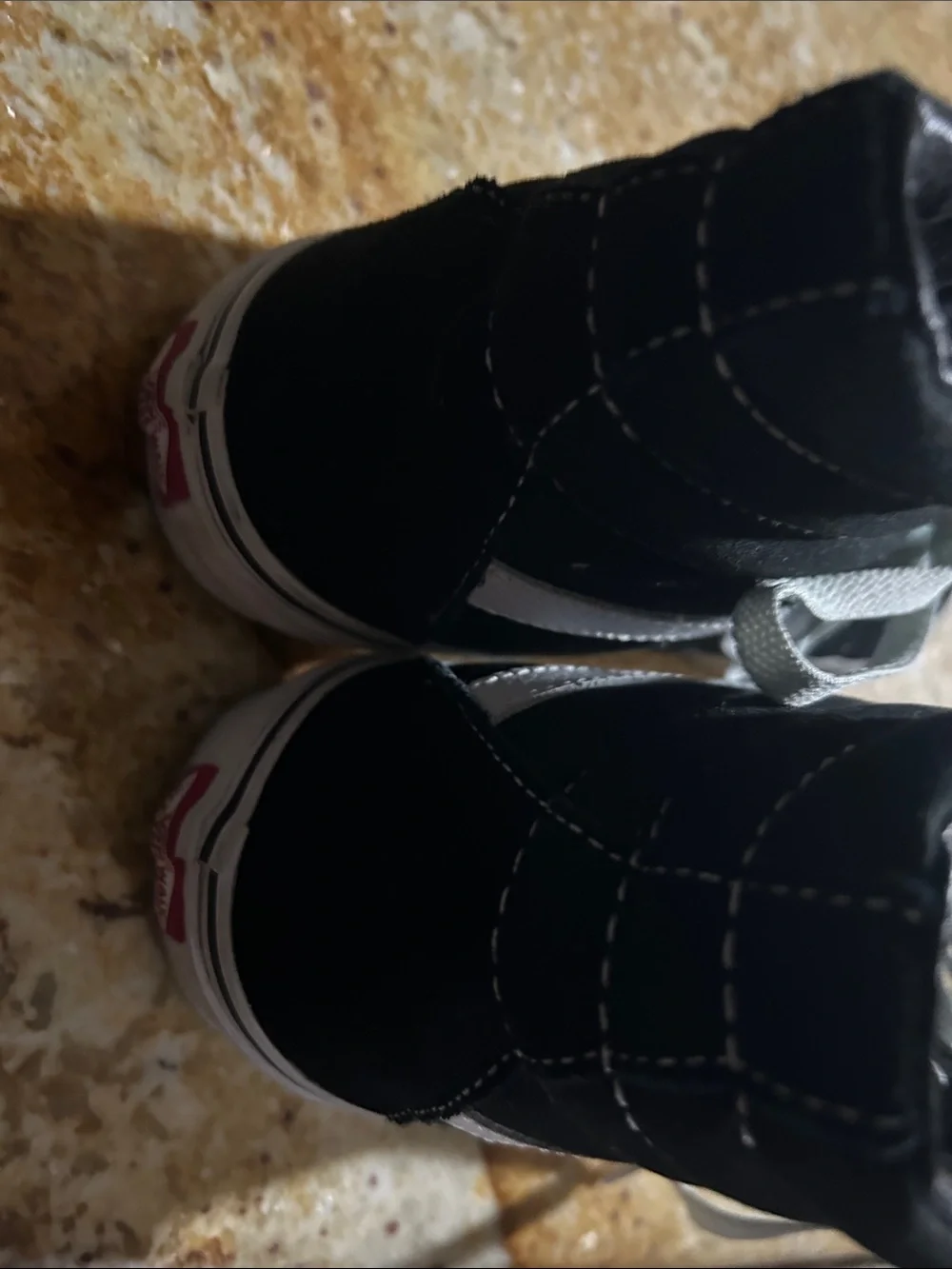 Vans women’s Black and White High-Top Skate Sneakers